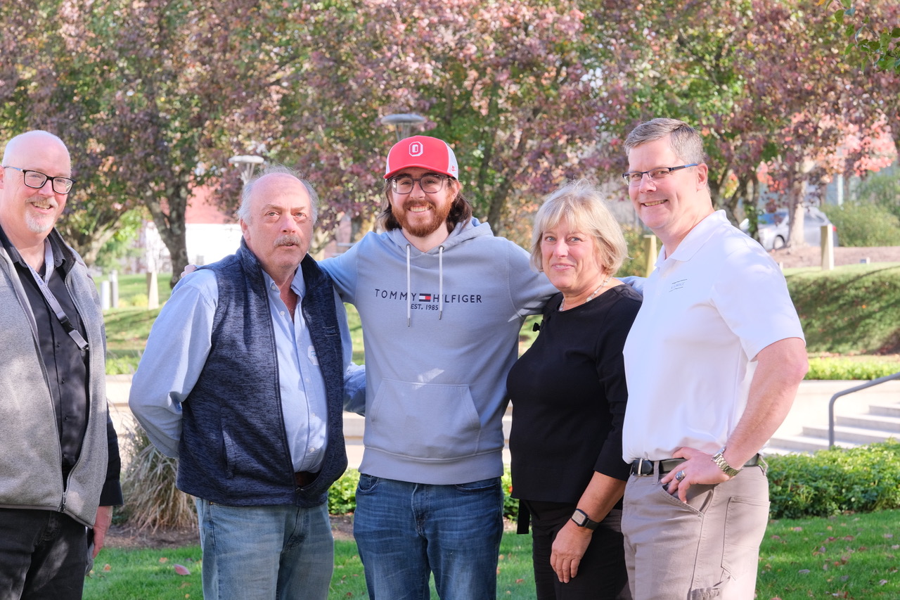 Four people standing in a group